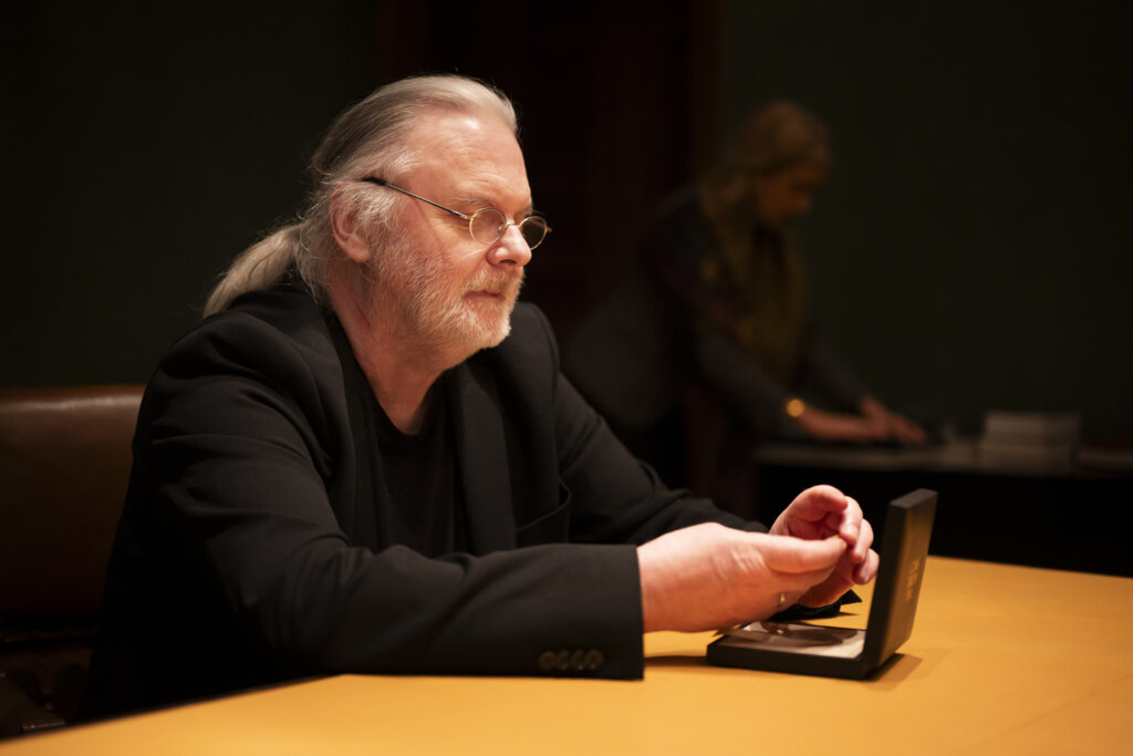Jon Fosse looks at his medal